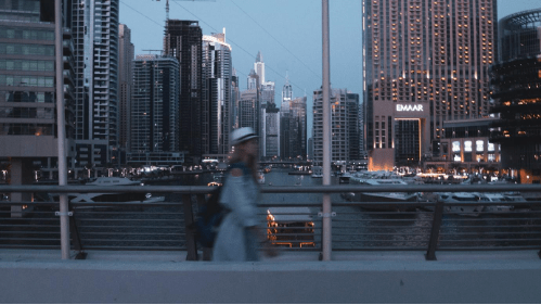 A woman walking along a bridge in the UAE.