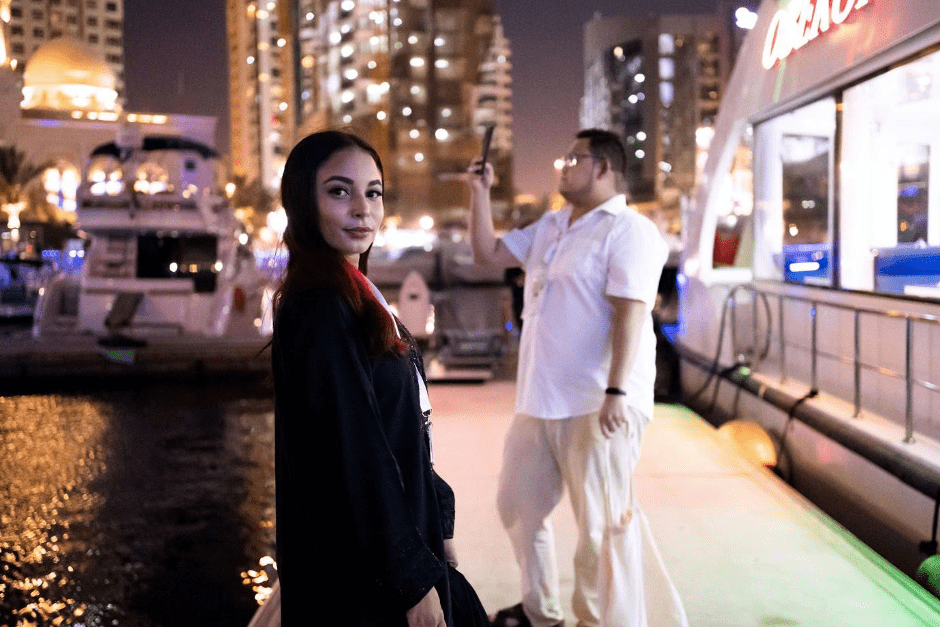 A girl standing next to a man in a white shirt